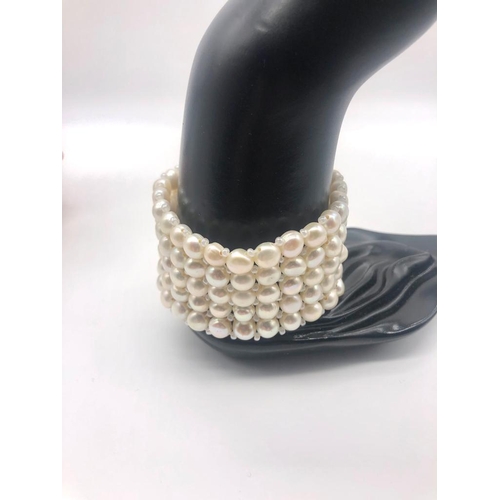 238 - Two Freshwater Pearl Flat-Back Button Cuff Bracelets. White and pink expandable five-row bracelets.