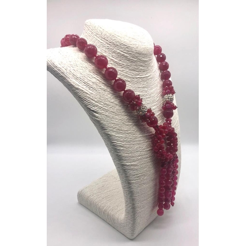 245 - A Faceted Fuchia-Pink Chalcedony Statement Necklace. Graduated beads leading to a large circular wre... 