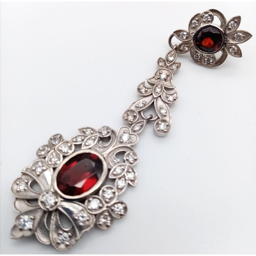 347 - 18K drop earrings garnets and diamonds. Length 17cm. 21.15 grams total.