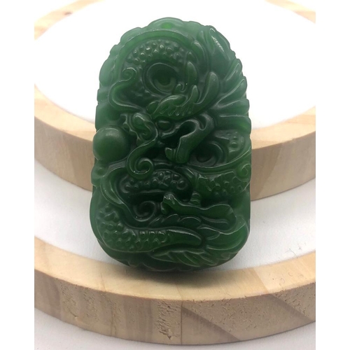 396 - A Green Jade Dragon-Image Carved Pendant. 5cm.