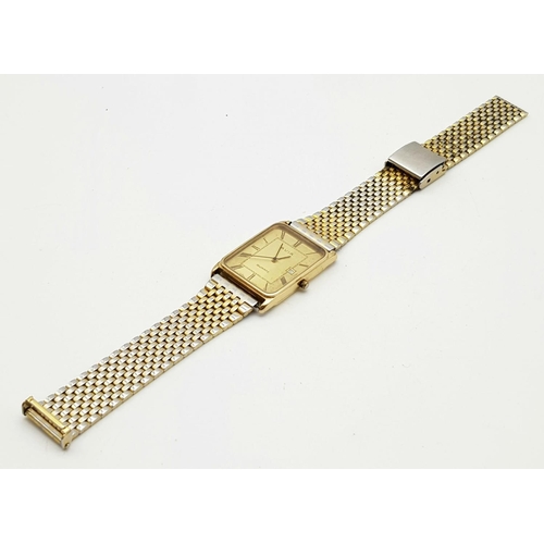 53 - A Vintage Avia 9K Gold Cased Watch. Gilded strap. Gold rectangular case - 33 x 23mm. Dial is worn on... 