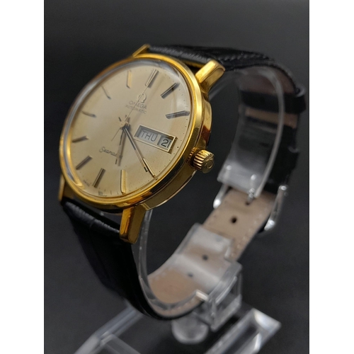 131 - A 1960s Omega Seamaster Gents Watch. Black leather strap and gold plated case - 35mm. Gold tone dial... 