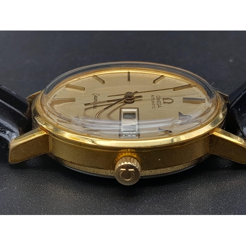 131 - A 1960s Omega Seamaster Gents Watch. Black leather strap and gold plated case - 35mm. Gold tone dial... 