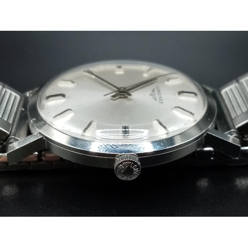 96 - A Classic 1970s Longines Gents Watch. Fitted with a speidel expandable stainless steel strap for add... 