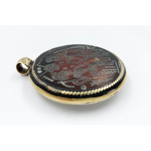 244 - An Ancient Hardstone Intaglio in a Yellow and White Metal Pendant Mount. 5cm diameter.