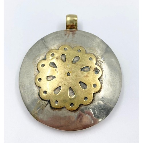 244 - An Ancient Hardstone Intaglio in a Yellow and White Metal Pendant Mount. 5cm diameter.