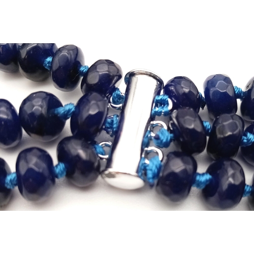 104 - A substantial three strand multifaceted blue sapphire necklace. Length: 48-54 cm, weight: 112g.