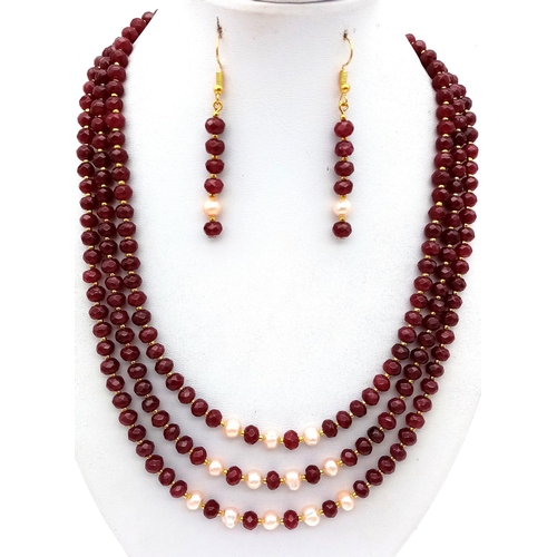 118 - A three strand necklace with multifaceted rubies and genuine pink pearls with a complimenting facete... 