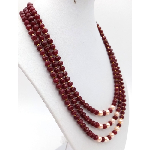 118 - A three strand necklace with multifaceted rubies and genuine pink pearls with a complimenting facete... 