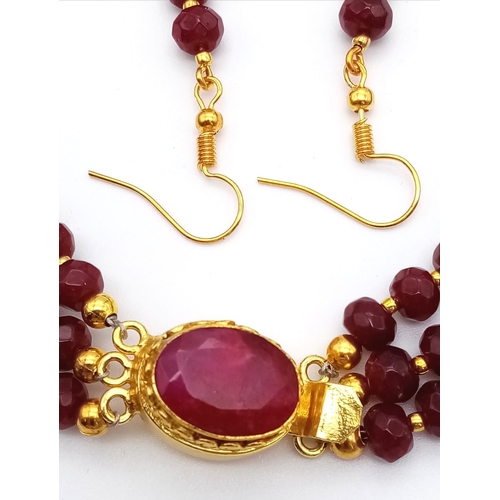 118 - A three strand necklace with multifaceted rubies and genuine pink pearls with a complimenting facete... 