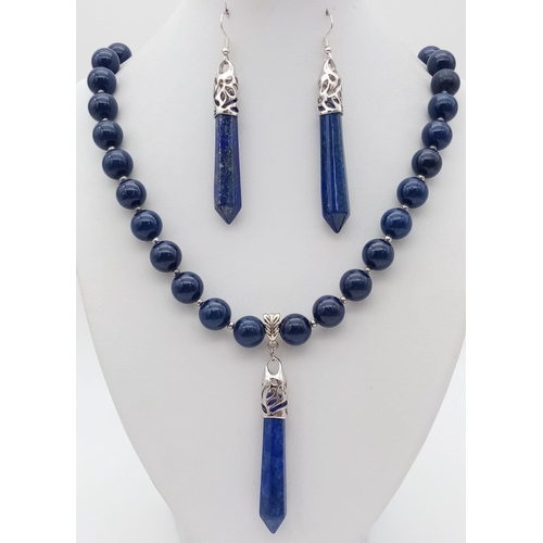 125 - A very noticeable lapis lazuli necklace and earrings set with large obelisk pendants. Necklace lengt... 