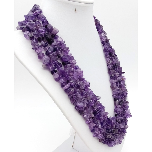 202 - A statement, four strand, irregular shaped amethyst necklace. Length: 49-57 cm, weight: 162 g.