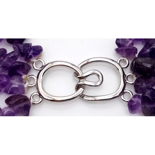 202 - A statement, four strand, irregular shaped amethyst necklace. Length: 49-57 cm, weight: 162 g.