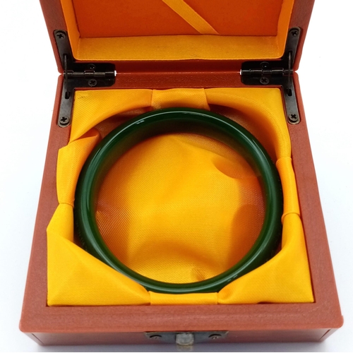 209 - A Tibetan, Buddhist, green jade bangle, with mantras engraved on the surface of the bangle. Internal... 