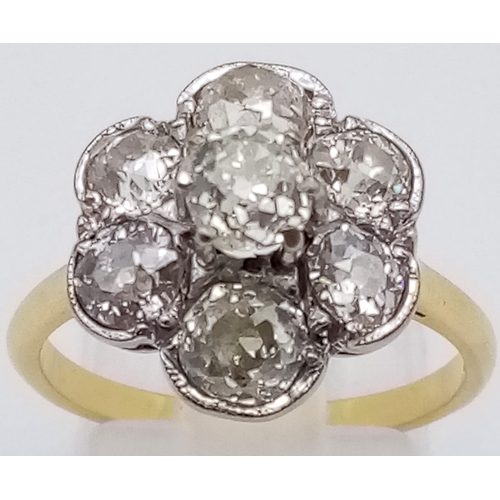 78 - An 18K Yellow Gold Diamond Floral Cluster Ring. Quality centre stone surrounded by six quality diamo... 