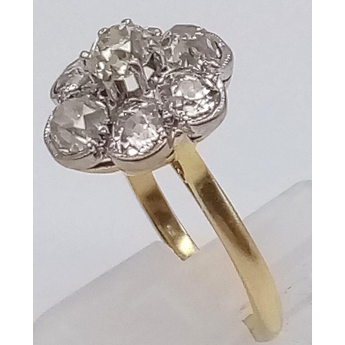 78 - An 18K Yellow Gold Diamond Floral Cluster Ring. Quality centre stone surrounded by six quality diamo... 