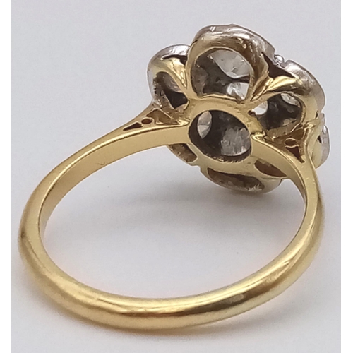 78 - An 18K Yellow Gold Diamond Floral Cluster Ring. Quality centre stone surrounded by six quality diamo... 