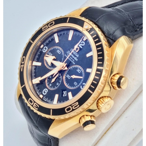 99 - An Omega Seamaster Planet Ocean 600M Co-Axial Chronograph 18K Gold Gents Watch. Black leather and ro... 