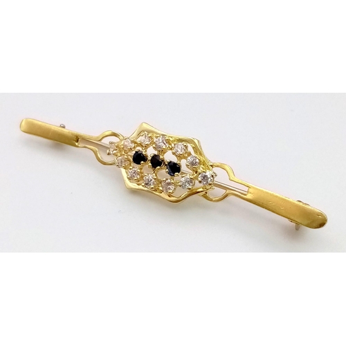 124 - A STYLISH 9K GOLD BAR BROOCH WITH SAPPHIRE AND WHITE STONES.  4.8gms