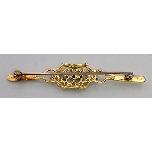 124 - A STYLISH 9K GOLD BAR BROOCH WITH SAPPHIRE AND WHITE STONES.  4.8gms