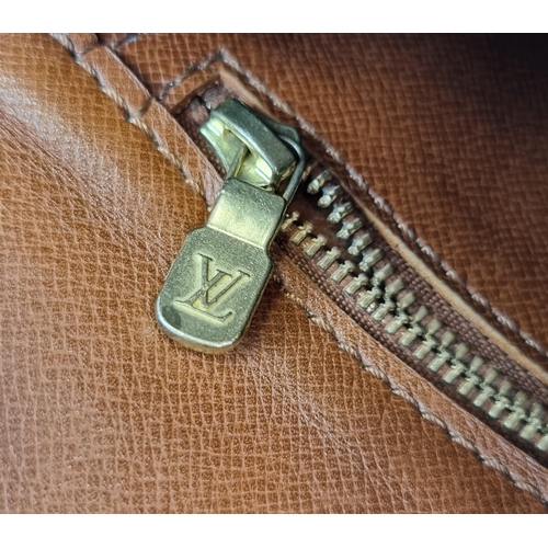 311 - A Louis Vuitton Saddle Crossbody Bag. Monogrammed brown canvas and leather exterior. Zipped interior... 