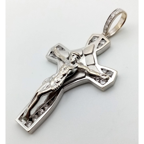 335 - A HEAVY STONE SET 9K WHITE GOLD CRUCIFIX.  13.3gms