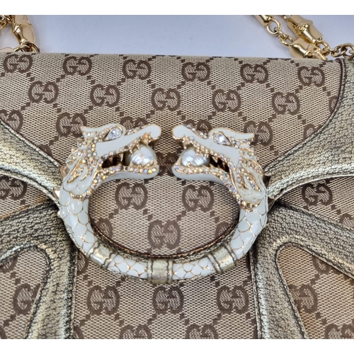 47 - A Gucci Dionysus Dragons Head Handbag. Beige monogrammed cloth with gilded touches and hardware. Twi... 