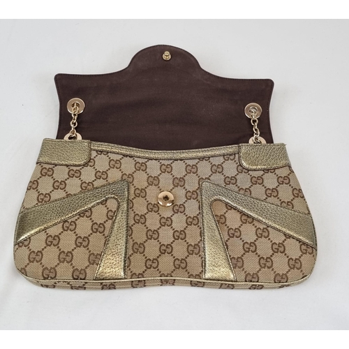 47 - A Gucci Dionysus Dragons Head Handbag. Beige monogrammed cloth with gilded touches and hardware. Twi... 