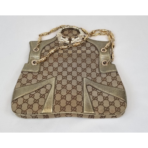 47 - A Gucci Dionysus Dragons Head Handbag. Beige monogrammed cloth with gilded touches and hardware. Twi... 