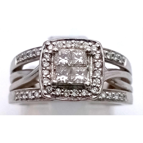 134 - A 950 Platinum Diamond Ring. Four central diamonds surrounded by a square of diamonds. Piercing deco... 