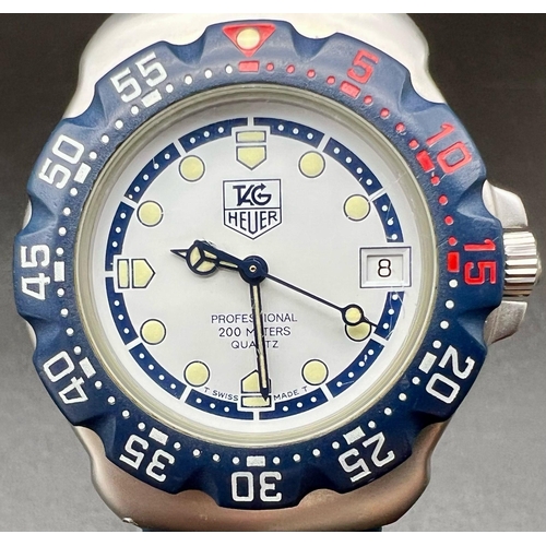 143 - A Tag Heuer Professional 200 Metres Quartz Divers Watch. Blue rubber strap. Rotating bezel. White an... 