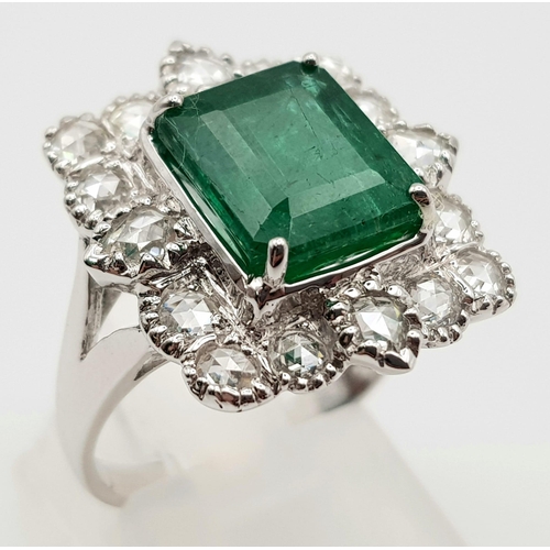 10 - A WGI Certified 18K White Gold Emerald and Diamond Ring. A 4.1ct centre cut natural emerald surround... 