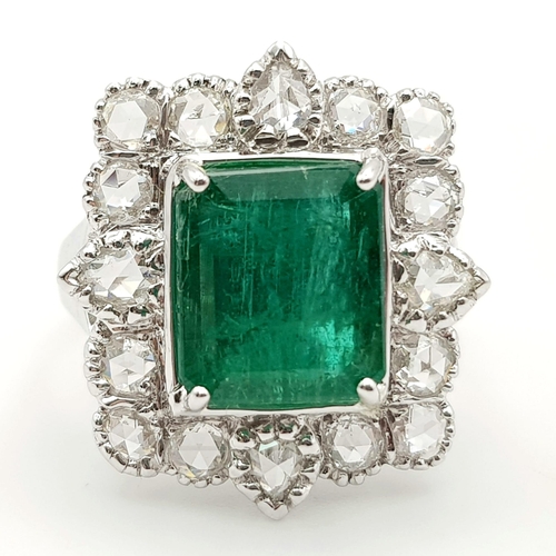 10 - A WGI Certified 18K White Gold Emerald and Diamond Ring. A 4.1ct centre cut natural emerald surround... 