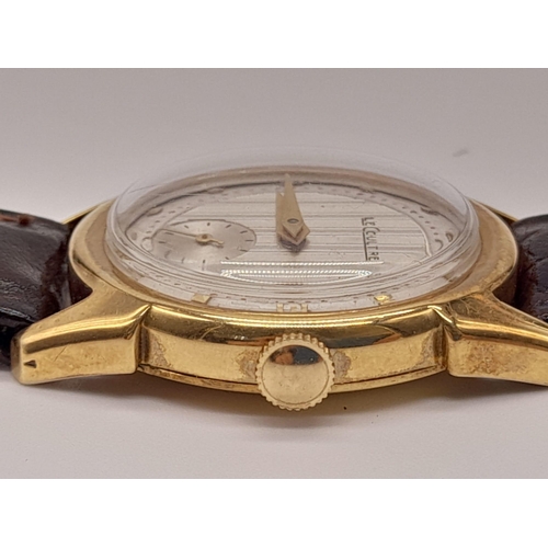 227 - A Vintage Le Coultre Gold Gents Watch. Leather strap. Gold case - 32mm. Two-tone dial with sub secon... 