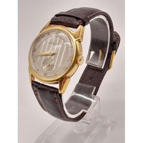 227 - A Vintage Le Coultre Gold Gents Watch. Leather strap. Gold case - 32mm. Two-tone dial with sub secon... 