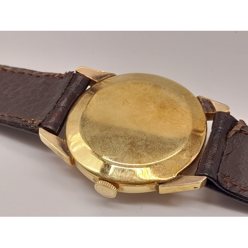 227 - A Vintage Le Coultre Gold Gents Watch. Leather strap. Gold case - 32mm. Two-tone dial with sub secon... 