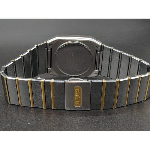 256 - A Rado Jubile Quartz Gents Watch. 18K gold and stainless steel strap. Case - 34 x 28mm. Black dial w... 