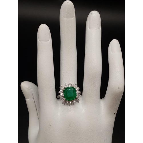 57 - A GIA Certified 18K White Gold Emerald and Diamond Ring. 4.35ct central octagonal-cut emerald surrou... 