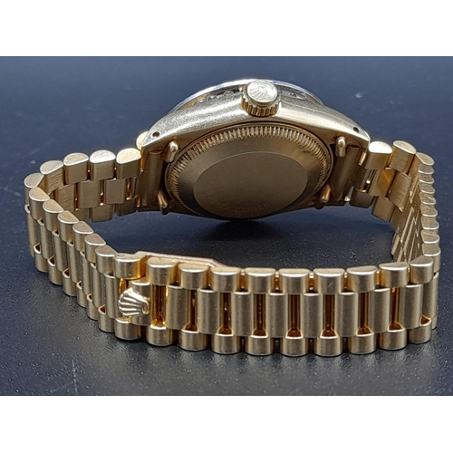 87 - An 18K Gold and Diamond Rolex Oyster Perpetual Datejust Ladies Watch. 18k gold strap and case - 26mm... 