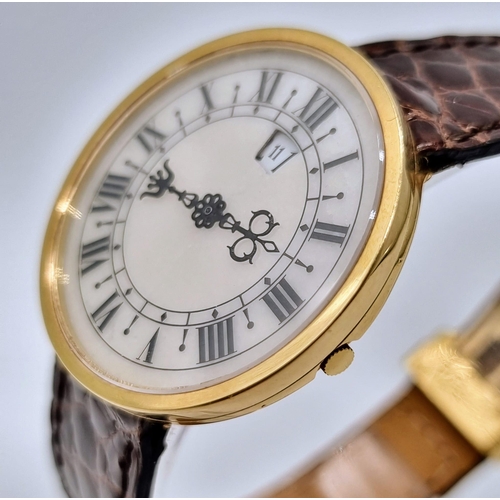 472 - An 18K Gold Hour Window and Elaborate Minute Pointer Watch. Leather and 18k gold strap. 18k gold cas... 