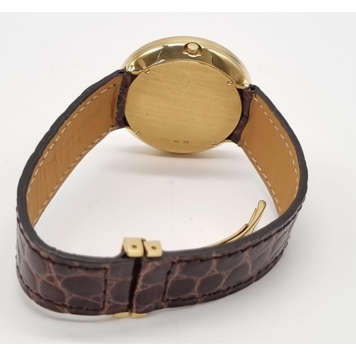 472 - An 18K Gold Hour Window and Elaborate Minute Pointer Watch. Leather and 18k gold strap. 18k gold cas... 