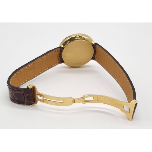 472 - An 18K Gold Hour Window and Elaborate Minute Pointer Watch. Leather and 18k gold strap. 18k gold cas... 