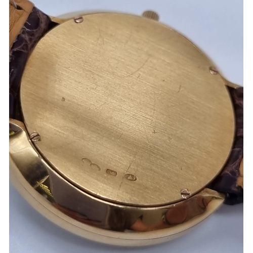 472 - An 18K Gold Hour Window and Elaborate Minute Pointer Watch. Leather and 18k gold strap. 18k gold cas... 