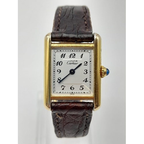 474 - An 18K Gold Must de Cartier Ladies Tank Watch. Brown leather strap and gold buckle. 18k gold case - ... 