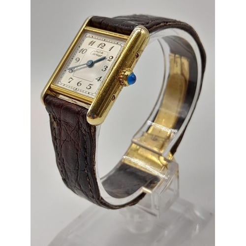 474 - An 18K Gold Must de Cartier Ladies Tank Watch. Brown leather strap and gold buckle. 18k gold case - ... 