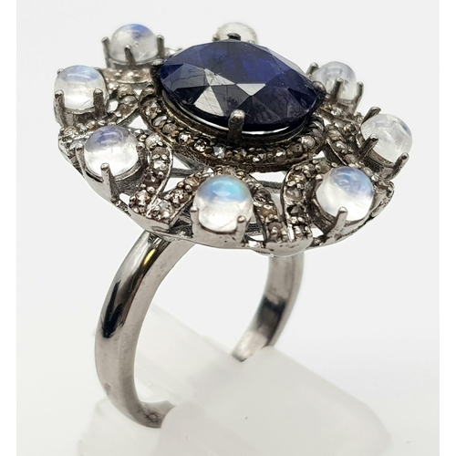 397 - 6.10ct Blue Sapphire Ring with a 3.15ct Moonstone and 1.10ct Diamonds in a Pave Setting. Size P.