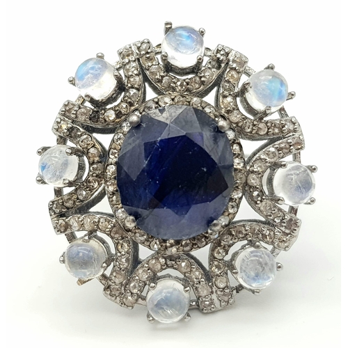 397 - 6.10ct Blue Sapphire Ring with a 3.15ct Moonstone and 1.10ct Diamonds in a Pave Setting. Size P.