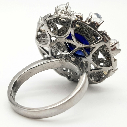 397 - 6.10ct Blue Sapphire Ring with a 3.15ct Moonstone and 1.10ct Diamonds in a Pave Setting. Size P.