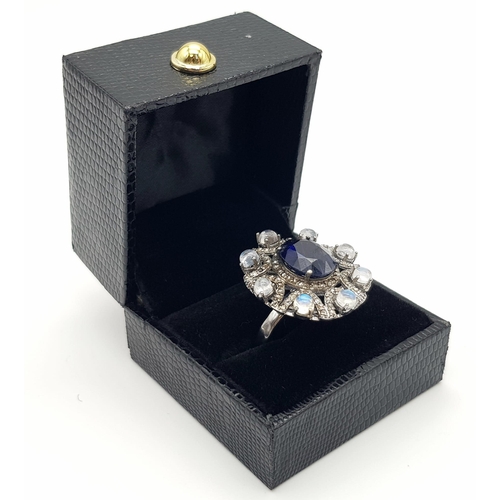 397 - 6.10ct Blue Sapphire Ring with a 3.15ct Moonstone and 1.10ct Diamonds in a Pave Setting. Size P.