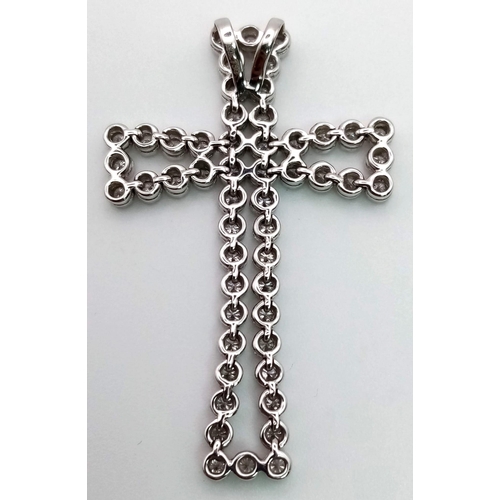 114 - An 18K White Gold Diamond Cross Pendant. 5ct of exceptional bright round-cut diamonds create a heave... 